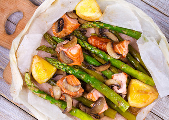 Salmon, Asparagus, Mushrooms and Lemon in Parchment. View from above, top studio shot