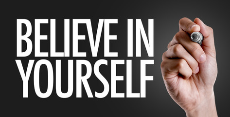 Hand writing the text: Believe in Yourself