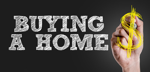 Hand writing the text: Buying a Home