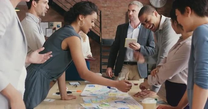 Steadicam shot in of creative diverse business team meeting 