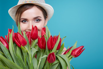 Young beautiful woman studio portrait with tulip flowers