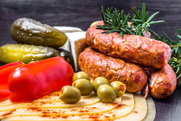 Ingredients of breakfast with cheese slices, sausage and vegetables