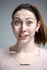 Portrait of young woman with shocked facial expression