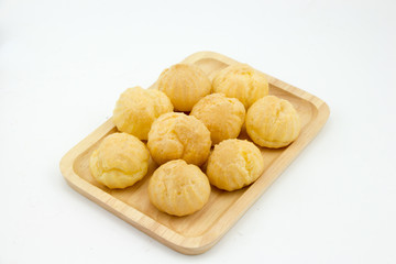 Choux cream in wooden plate white background 