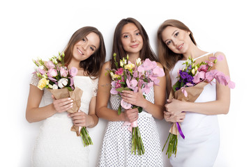 Three  women holding bunch of flowers