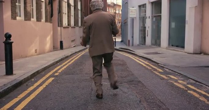 Contemporary funky elderly man street dancer dancing freestyle in the city