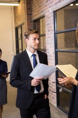 Lawyer looking at documents and interacting with businessman