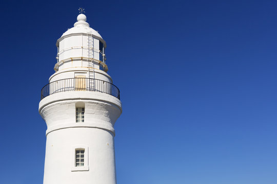 White lighthouse on a clear blue day
