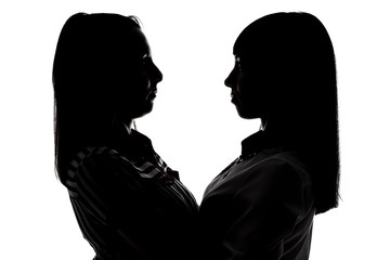Silhouette of women looking at each other 