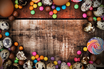 Chocolate and  Easter Eggs Over Wooden Background