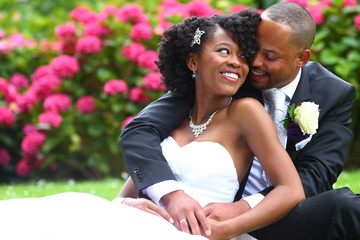 marriage/ a happily married couple smiling at each other at their wedding day