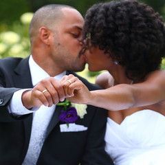 wedding kiss/  couple happily kissing and showing their wedding rings on their wedding day