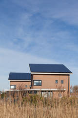 Family house with solar panels for alternative energy