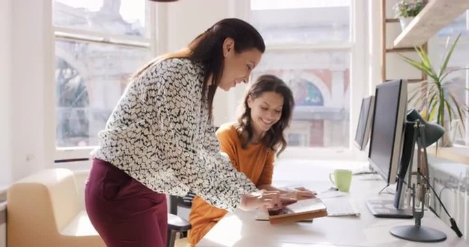 Business woman using tablet app showing 3d printed model of geodesic dome walking through modern office to diverse team meeting