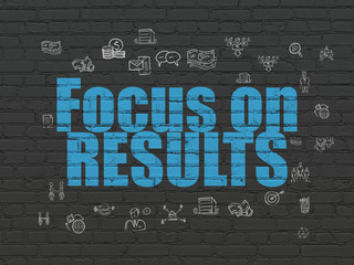Business concept: Focus on RESULTS on wall background