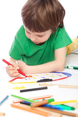 Boy doodling on white paper