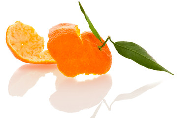 Spiral peel of orange mandarin citrus fruit with green leafs iso