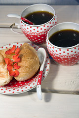 croissants and two cup of coffee on white wooden background