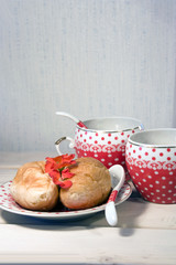 croissants and two cup of coffee on white wooden background