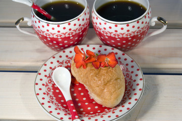 croissants and two cup of coffee on white wooden background