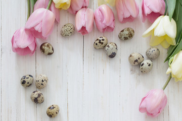 tulips and easter eggs on wooden background