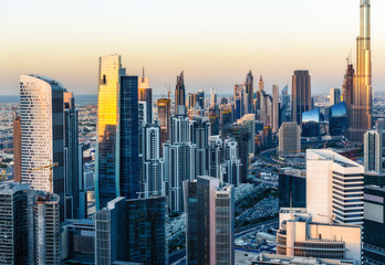 Fototapeta na wymiar Beautiful modern city architecture at sunset. View of Dubai's business bay towers.