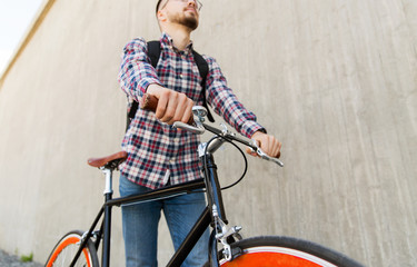 Fototapeta na wymiar hipster man with fixed gear bike and backpack