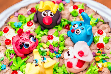 Fototapeta na wymiar Celebration colorful cake decorated with fruit, chocolate and fi