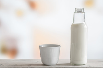 Obraz na płótnie Canvas Milk bottle and a cup