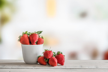 Red strawberries in a white cup