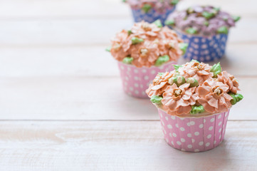 home made sponge cupcakes with flowers buttercream frosting