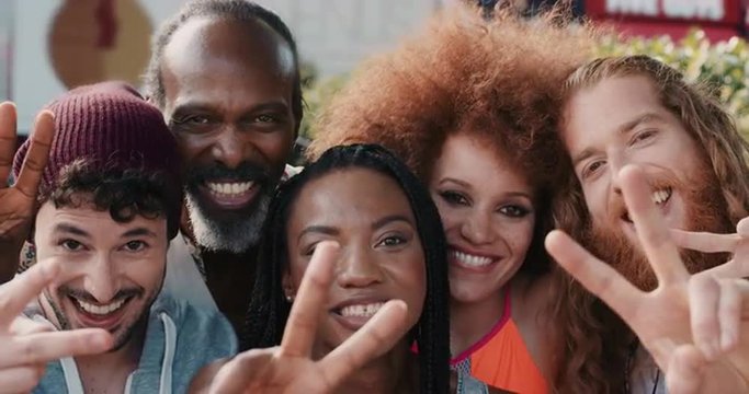 Slow Motion Portrait of multi ethnic group of people smiling peace sign
