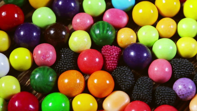 Multi-colored sweets, lollipops and chewing gum. dolly shot 