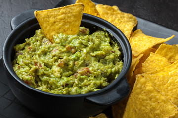 Bowl of guacamole with corn chips
