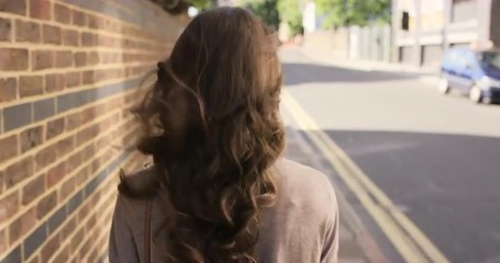 Beautiful woman walking through urban city streets