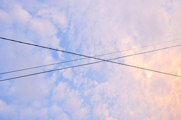 Electrical wires crossing over each other in the evening sky