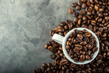 Coffee beans. Coffee cup full of coffee beans. Toned image.