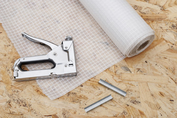 vapor barrier and mounting a stapler