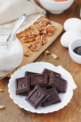 Ingredients for baking cake: chocolate, walnuts, eggs, milk, sugar and flour