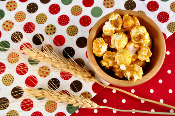 Popcorn close up with ear barley on background