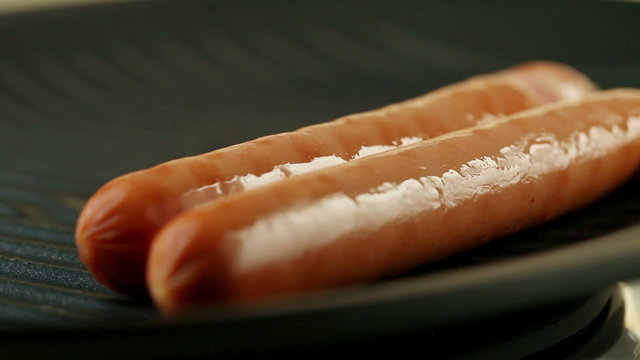 Sausages cooking in the frying pan