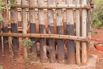 Strong wooden log cage with rhino inside. Sheldrick Elephant Orphanage in Nairobi, Kenya. 
