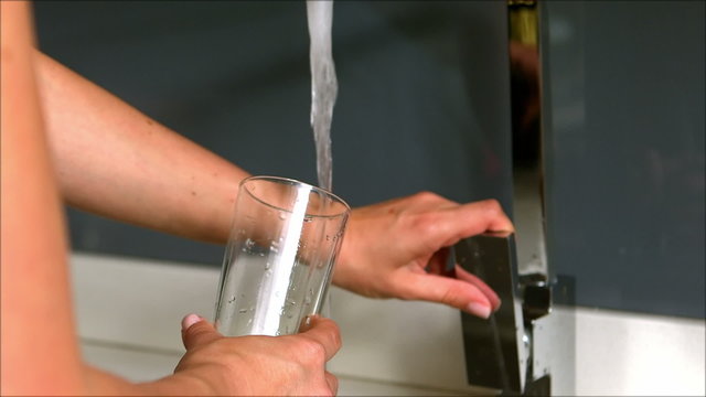 Woman pouring water in her glass