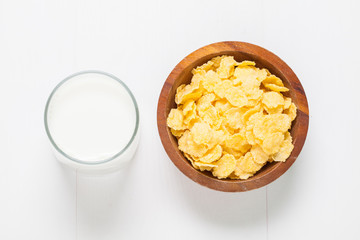 cornflakes with glass milk on wooden table