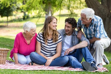 Smiling family sitting on a blanket