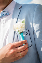 buttonhole on the groom's suit from a rose