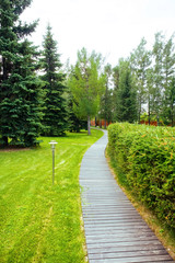 Pathway wooden winding in garden - horizontal
