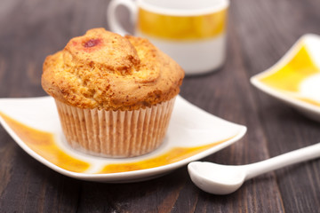 Cupcakes with tea on black wooden background