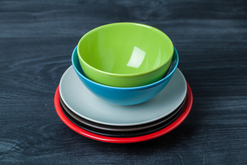 stack color plate and bowl on wooden table