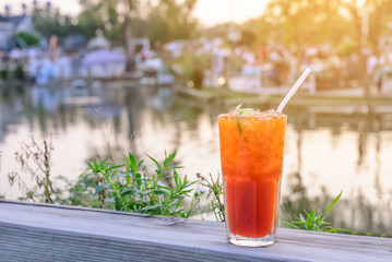 Iced lemon tea with sliced lemon and summer party background nea